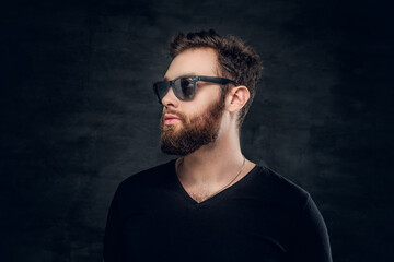 Fototapeta premium Stylish bearded male in sunglasses over grey background.