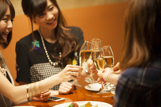 Women are toast with champagne in a luxurious restaurant