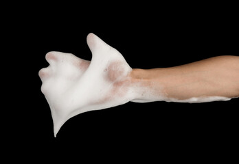 Hand of man with foam soap on black background