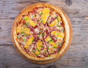 Whole pizza on a wooden tray