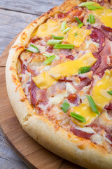 Whole pizza on a wooden tray