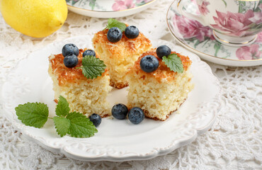 Homemade pie for tea from coconut, lemon and fresh berries blueberries.Rustic style. Selective focus