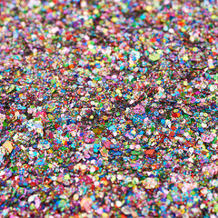 Fototapeta na wymiar Surface coated with colorful sequins