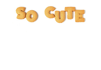 The word SO CUTE spelled with alphabet shaped biscuits, isolated on white background with free space for text and design 