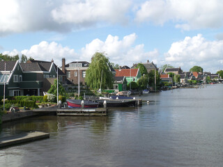 Fototapeta na wymiar Beautiful traditional Dutch waterfront houses of Zandaam, The Netherlands 