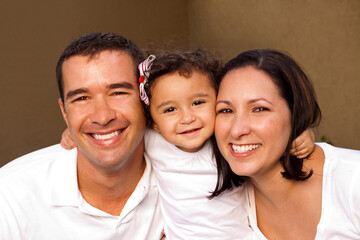 Happy Hispanic family laughing and smiling.