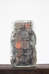 coins full fill jar for saving; banking; investment; financial; accounting concept