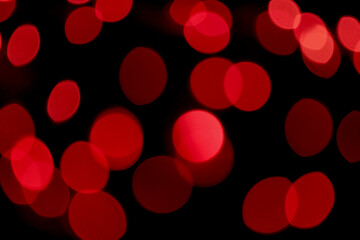 Out of focus, defocused, blurred, bokeh of red color light on black for abstract background