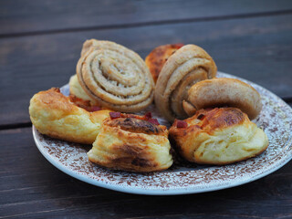 Homemade scones on plate on wooden table.