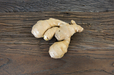Fresh ginger root on wood background.