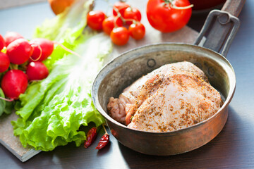 Marinated chicken meat in a pan and vegetables 