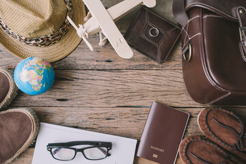 Travel accessories on wooden table, vintage color tone