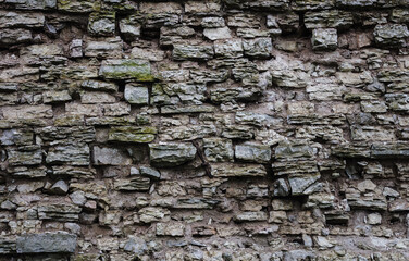 Old broken gray stone wall background