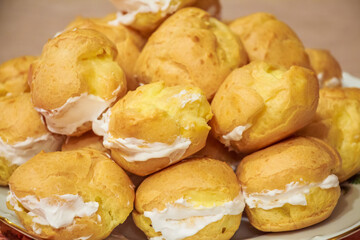 Close up of resh homemade profiteroles with cream