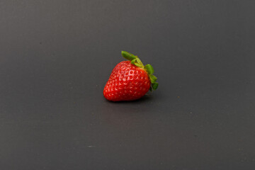 Fresh strawberry close up on grey background