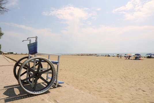 Special wheelchair with big steel wheels to cross the sandy beac