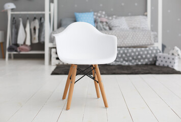 White modern plastic chair in children room