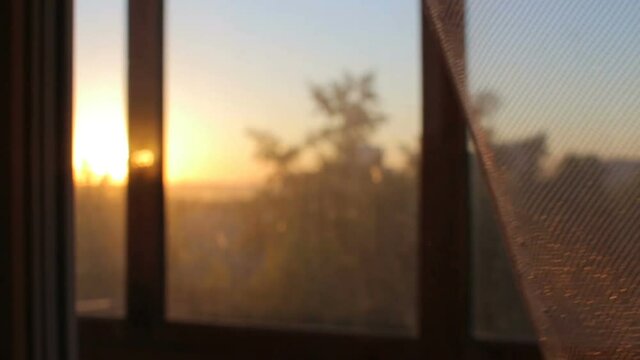 Closing transparent curtains at sunset sunrise close up view