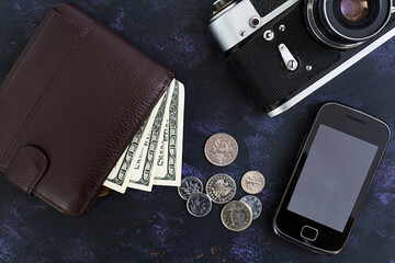 Retro camera, phone, money. Travel concept. Top view