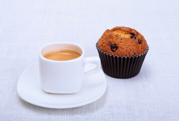 Fresh homemade muffin, cake and white cup of Cappuccino on white background.