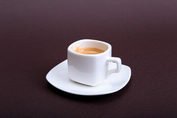 Classic espresso coffee in white cup isolated on dark background. Top View.