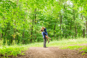 summer holidays, love, romance and people concept - happy smiling young couple hugging outdoors