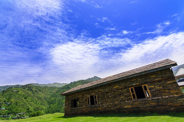 Fototapeta na wymiar Idyllic and beautiful landscape with an old abandoned wooden house