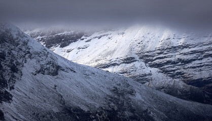 Fototapeta na wymiar A cloud and snow covered Beinn Eighe in the Scottish Highlands, Scotland, UK.