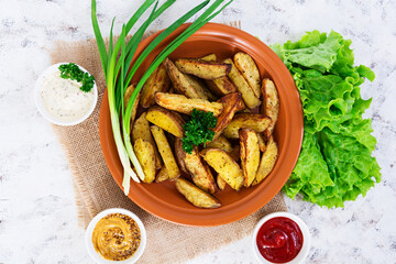 Baked potato wedges with spices. Top view
