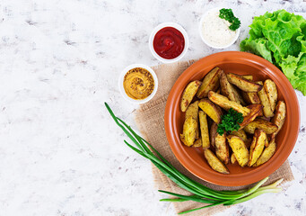 Baked potato wedges with spices. Top view