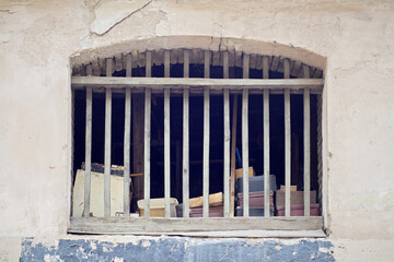 Old abandoned lumber room lot of suitcases, holey wooden window