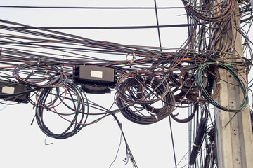 A tangle of cables and wires and telephon in Thailand, Asia