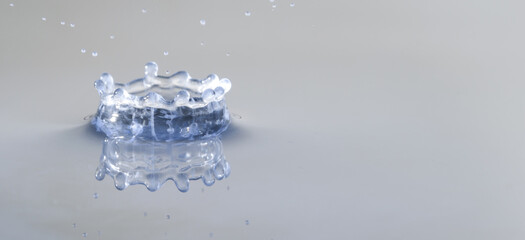 Splashes of water. Water drops. Photo of drop of a drop in water.