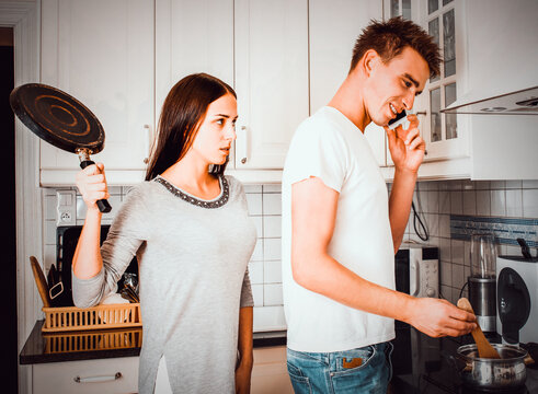 Aggressive woman with pan.