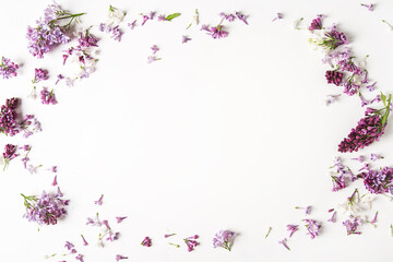 Spring flowers. Lilac flowers on white wooden background. Top view, flat lay