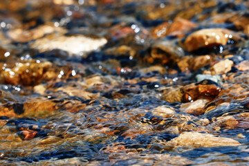 Multi-colored pebbles in a stream
