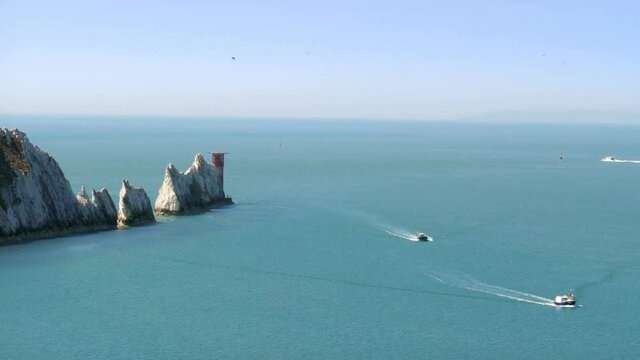 The Needles - is a row of three distinctive stacks of chalk that rise out of the sea off the western extremity of the Isle of Wight, UK, close to Alum Bay. 4K footage at 60fps.