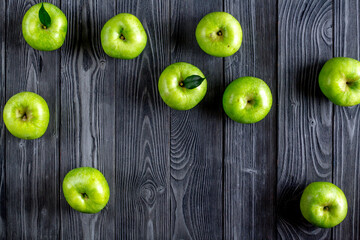 Fototapeta na wymiar ripe green apples dark wooden table background top view space for text