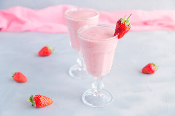 Fresh and Cold Strawberry Smoothie in Tall Glasses on Grey Background 