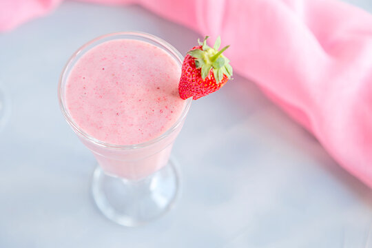 Fresh and Cold Strawberry Smoothie in Tall Glasses on Grey Background 
