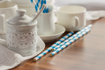 Set of white empty tableware with striped tubules