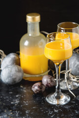 Traditional Italian yellow egg liquor, Bombardino. Dark background. Copy space.