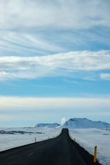 Lonely black road, snow, blue sky, Iceland