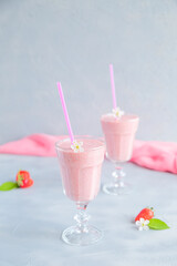Fresh and Cold Strawberry Smoothie in Tall Glasses on Grey Background 