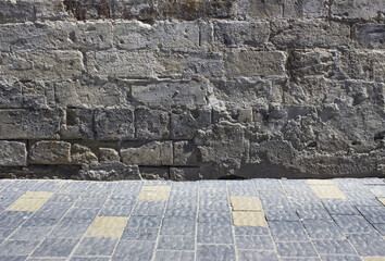 The old concrete wall with pavement stones