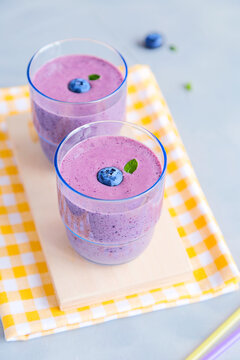 Fresh Cold Blueberry Smoothie in Glass Decorated with Yellow Fabric Napkin
