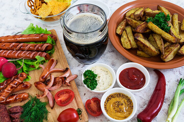 Baked potato wedges with sausages and spices