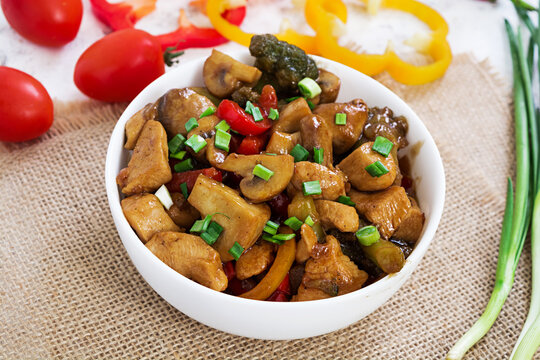 Stir Fry Chicken with peppers and mushrooms on white background