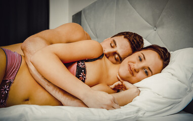 Young lovely couple in bed.