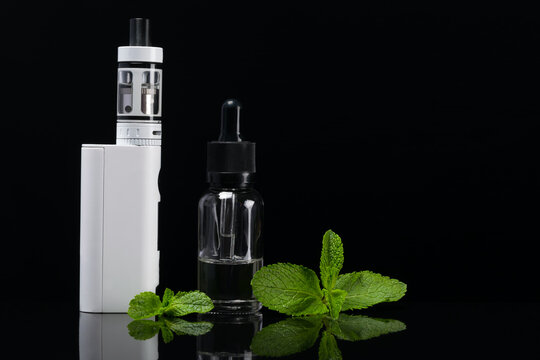 Mint flavor for an electronic cigarette with reflection on a black background